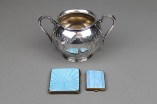 An Edwardian silver plated 2 handled sugar bowl, a metal and guilloche enamelled match sleeve and cigarette case