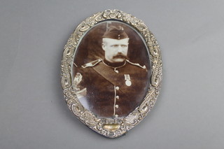 An Edwardian repousse silver oval photograph frame with vacant cartouche, Chester 1901 6 1/2" 