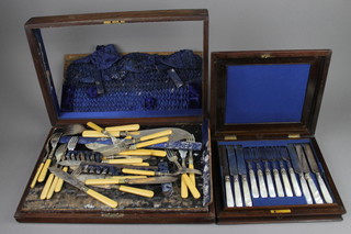 An Edwardian rosewood canteen of silver plated and mother of pearl fish eaters for 12, lacking 1 knife, a canteen of cutlery