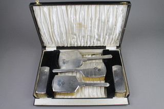 A cased 6 piece engine turned silver brush set and a ditto compact