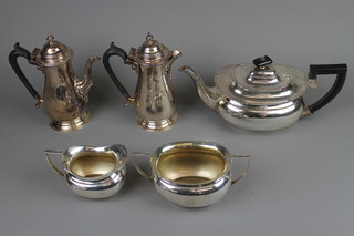 A silver plated 3 piece tea set and a pair of coffee and hot water jugs with ebonised handles