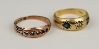 An 18ct gold gypsy ring set a diamond and 2 sapphires, size N and  a 9ct ditto set a garnet (stones missing), size O