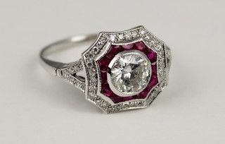 An 18ct white gold ruby and diamond Art Deco style cocktail ring, the centre stone approx .75ct surrounded by rubies and diamonds, size N 1/2 