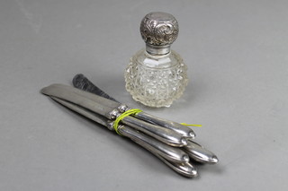 A silver mounted globular toilet bottle and 6 silver handled butter knives 