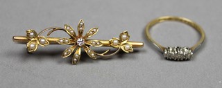 An Edwardian gold diamond and pearl set floral bar brooch, an 18ct gold 3 stone diamond ring 