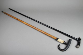 A silver mounted ebonised walking stick, a horn handled ditto