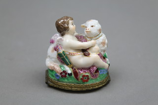 A 19th Century Continental polychrome porcelain patch box in the form of an Angel embracing sheep with gilt metal mounts 1 1/2" (f)