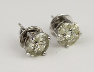A pair of 18ct white gold diamond cluster ear studs, the centre brilliant surrounded by 4 oval cut stones