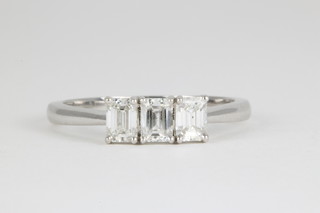 An 18ct white gold baguette cut 3 stone diamond ring, approx. 0.9ct, size P 1/2 