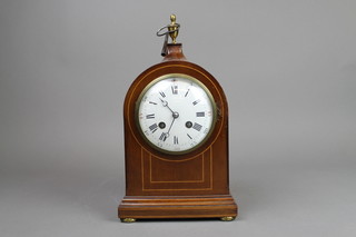 A D Mougin, an Edwardian 8 day striking mantel clock, the dial with Roman numerals  contained in an arched inlaid mahogany case surmounted by a gilt metal urn 
