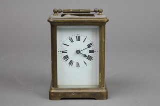 A 19th Century French carriage timepiece with enamelled dial and Roman numerals contained in a gilt metal case 