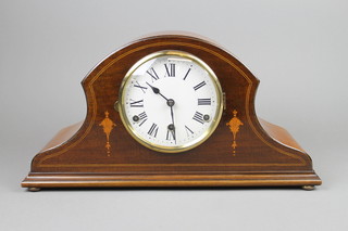 A 1920's 8 day striking mantel clock with enamelled dial and Roman numerals contained in an inlaid mahogany arch shaped case 