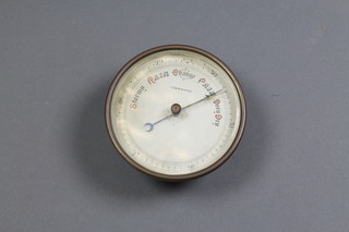 An aneroid barometer with silvered dial contained in a brass case 5" 