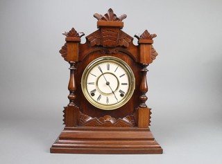 An Ansonia 8 day striking shelf clock with paper dial and Roman numerals contained in a walnut case 