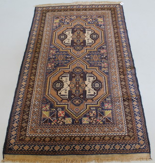 A contemporary brown ground rug with stylised octagons to the centre 77" x 44" 