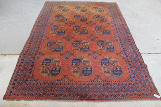 A red ground Afghan carpet with 15 octagons to the centre 112" x 78" 