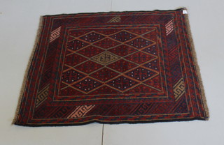 A red and blue ground tribal Gazak rug with stylised diamond panels to the centre 45" x 41"