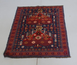 A Persian blue and red ground Belouche rug with floral ground 49" x 47 1/2" 