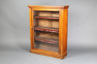 A Victorian rectangular walnut pier cabinet, fitted adjustable shelves enclosed by a glazed panelled door, raised on bun feet 42"h x 33"w x 11"d 