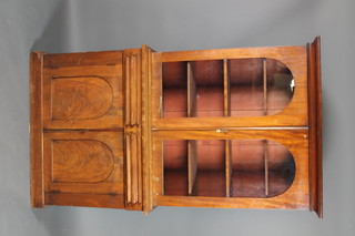 A Victorian mahogany bookcase on cabinet, the upper section with moulded cornice the interior fitted adjustable shelves enclosed by arch panelled doors, the base fitted 2 long drawers above a double cupboard, raised on a platform base 81 1/2"h x 46"w x 17"d 