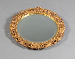 A circular bevelled plate wall mirror contained in a gilt plaster frame 16" 