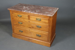 A Victorian pine chest of 2 short and 2 long drawers with brass plate drop handles, raised on a platform base with pink veined marble top (marble cracked) 31"h x 42"w x 20"d 