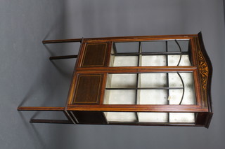 An Edwardian arch shaped inlaid mahogany display cabinet, the interior fitted shelves enclosed by astragal glazed doors, raised on square tapered feet 68"h x 36"w x 11 1/2"d 