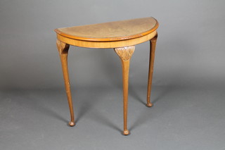 A Queen Anne style figured walnut demi-lune table, raised on cabriole supports 29"h x 28"w x 14 1/2"d 