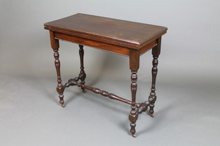 A late Victorian rectangular walnut card table, raised on turned supports with H framed stretcher 29"h x 33"w x 15"d 