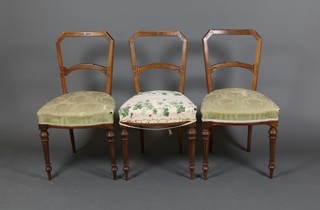 A set of 3 Victorian carved walnut bar back dining chairs with shaped mid rails, raised on turned and fluted supports 