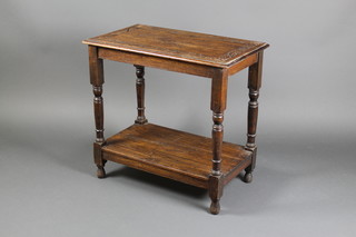 A Victorian rectangular carved oak 2 tier occasional table, raised on turned and block supports 28 1/"h x 30"w x 17"d