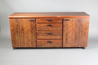 A 20th Century rectangular Heals sideboard fitted 4 long drawers flanked by a pair of cupboards 28 1/2"h x 64"w x 21 1/2"d