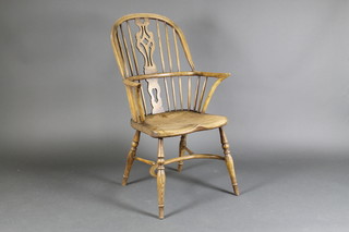 A 20th Century bleached elm stick and bar back Windsor chair with solid seat and crinoline stretcher raised on turned supports  