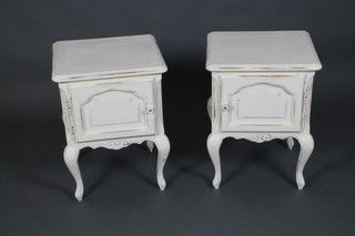 A pair of French painted elm? bedside cabinets enclosed by arched panelled doors, raised on cabriole supports 23"h x 17 1/2"w x 16 1/2"d 