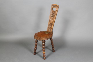 A Victorian carved oak spinning chair, the seat of lozenge form raised on bobbin turned supports with presentation plaque "Presented to Mr W T Daw by the Committee of Bridgwater Baptist Bazaar" (split to back)