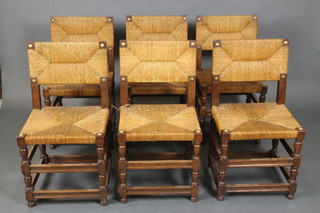 A set of 6 oak dining chairs with woven rush seats and backs, raised on turned and block supports