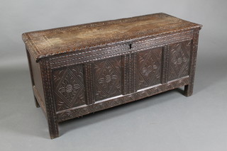 An 18th Century carved oak coffer of panelled construction with hinged lid, 24"h x 45"w x 19"d (split to lid)