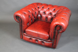 A Chesterfield style armchair upholstered in red leather