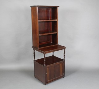 An Edwardian mahogany bookcase on cabinet, the upper section fitted adjustable shelves the base fitted a recess above cupboard, raised on turned supports 56"h x 20"w x 16"d  
