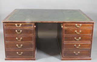 A mahogany partners desk with inset green leather writing surface, the pedestals fitted cupboards, 1 long and 3 short drawers, raised on a platform base 30"h x 64"w x 50"d 