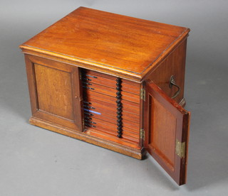 A Victorian mahogany collector's cabinet fitted 16 drawers with turned ebony handles enclosed by panelled doors, with drop handles to the sides, 12"h x 17 1/2"w x 15 1/2"d  