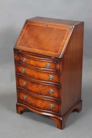 A Georgian style inlaid mahogany bureau with well fitted interior, the fall front above 4 long bow front drawers, raised on bracket feet 37"h x 21"w x 16"d 