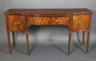 A Georgian mahogany sideboard of serpentine outline, fitted 1 long drawer flanked by 2 short drawers raised on square tapered and reeded supports 37"h x 71"w x 27"d 