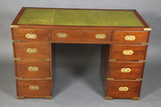 A military style kneehole desk with inset green leather writing surface, fitted 1 long and 8 short drawers with brass drop handles to the side 30"h x 47 1/2"w x 23 1/2"d