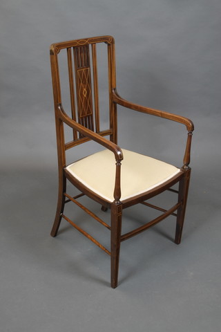 An Edwardian inlaid mahogany stick and rail back open arm chair raised on square tapering supports united by a stretcher with old repairs to arms