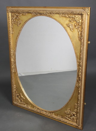 An oval plate wall mirror contained in a rectangular gilt plaster frame 46" x 36"  