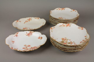 A Limoges part dinner service comprising 2 oval shaped dishes and 11 plates decorated with Autumnal flowers 