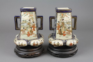 A pair of Japanese Satsuma tapered vases with quadripod baluster legs decorated with panels of figures 6"