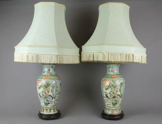 A pair of 1960's famille verte baluster vases decorated with panels of figures on horseback converted to electricity 12" 