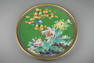 A green ground cloisonne dish decorated with a bird amongst flowers within a geometric border 15" 